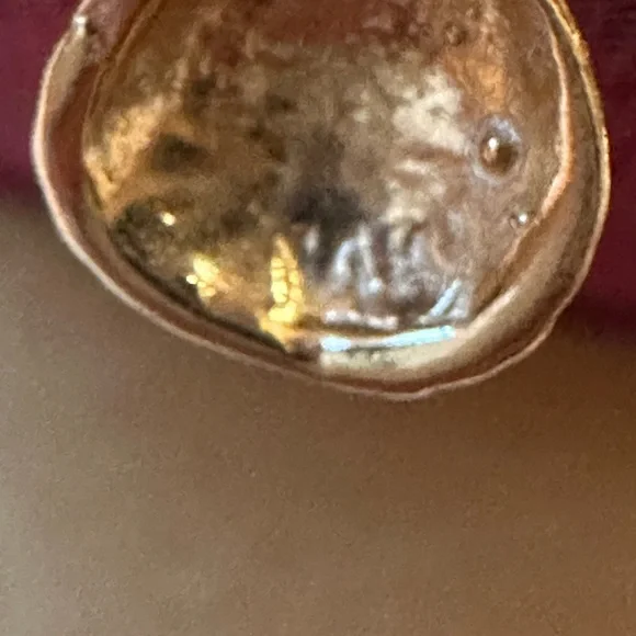 14 karat yellow gold cable ring with a beautiful shell hanging
